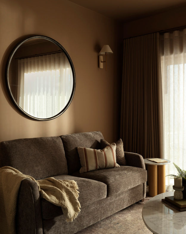 Snug with wave curtains and sheer voiles on an antique brass track