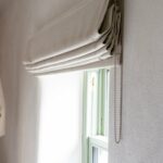 Folds and chain operation detail of a made-to-measure Roman blind, Midlands Gem
