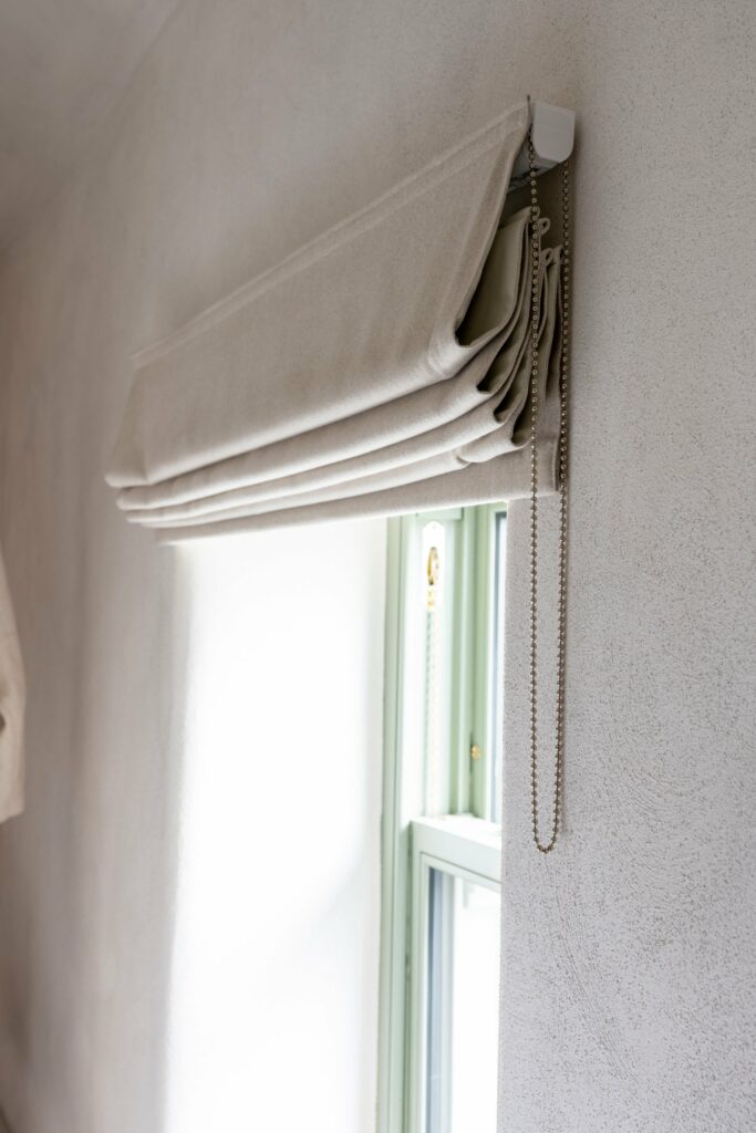 Folds and chain operation detail of a made-to-measure Roman blind, Midlands Gem