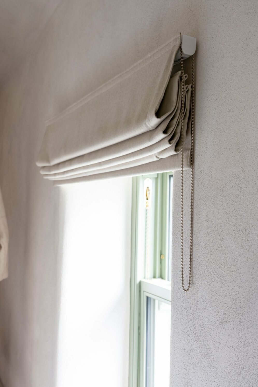 Folds and chain operation detail of a made-to-measure Roman blind, Midlands Gem