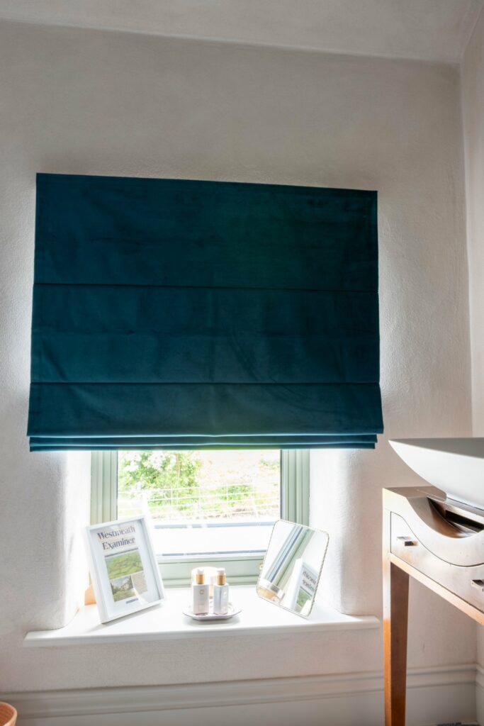 Teal velvet Roman blind in a bathroom of the Midlands Gem stone house