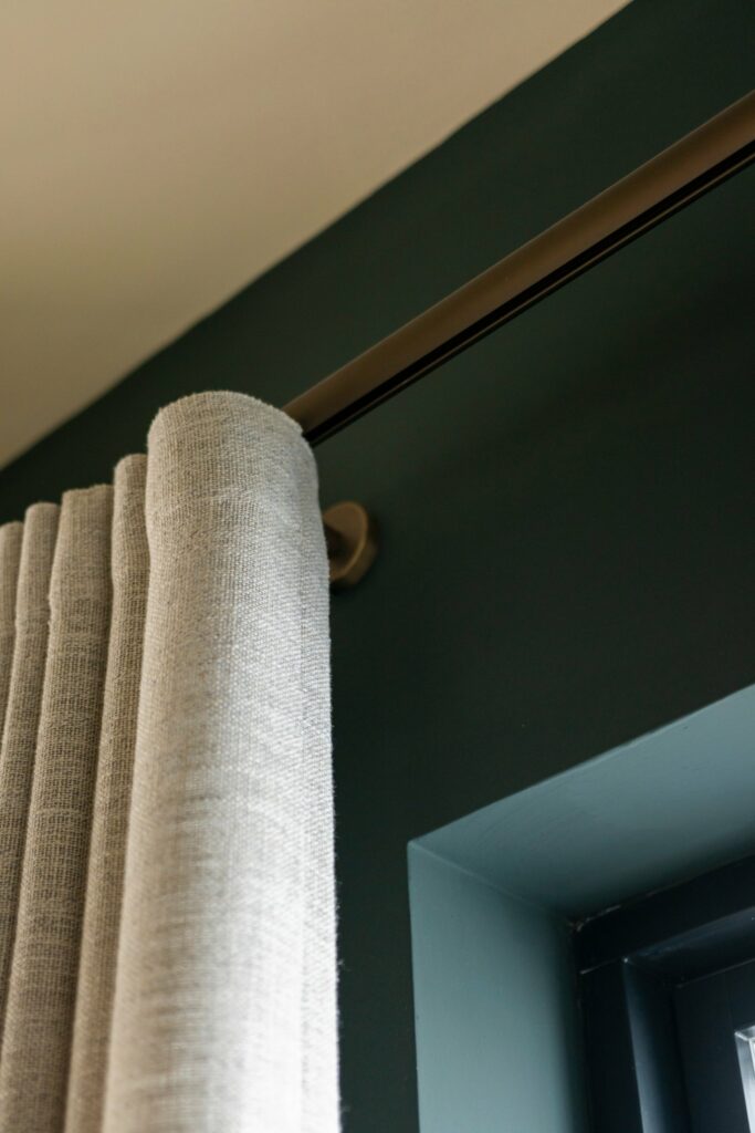 Close-up of a wave curtain heading on a satin gold Techno 30 electric curtain track