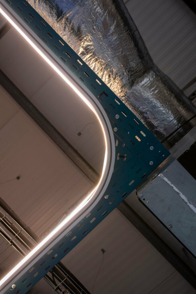 Bent curtain track with LED lighting suspended under the open ceiling at PGIM Letterkenny