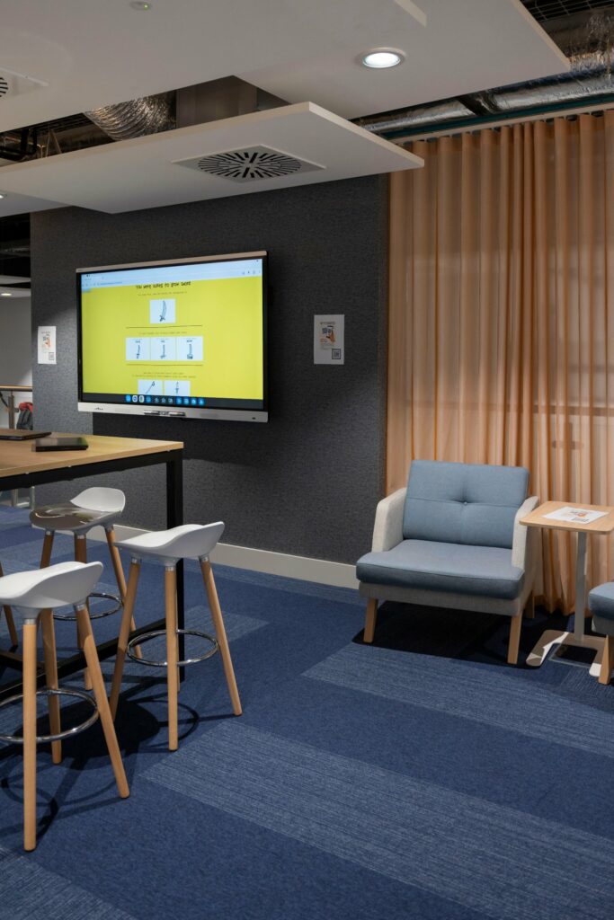 Breakout area at PGIM Letterkenny with ceiling-height curtains on a motorised track