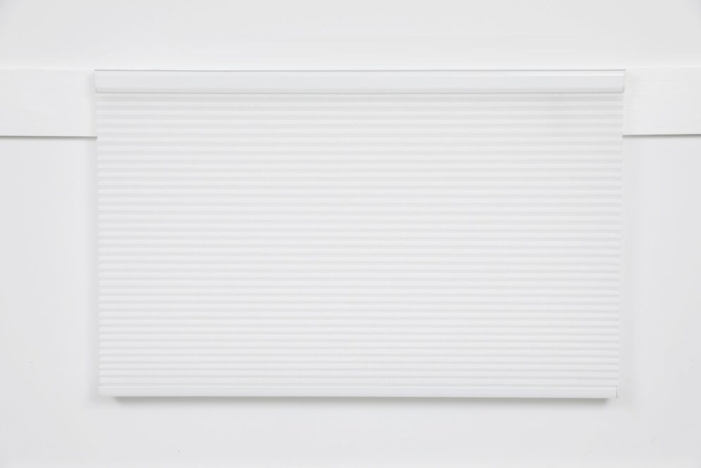 White made-to-measure pleated blind with slim white headrail