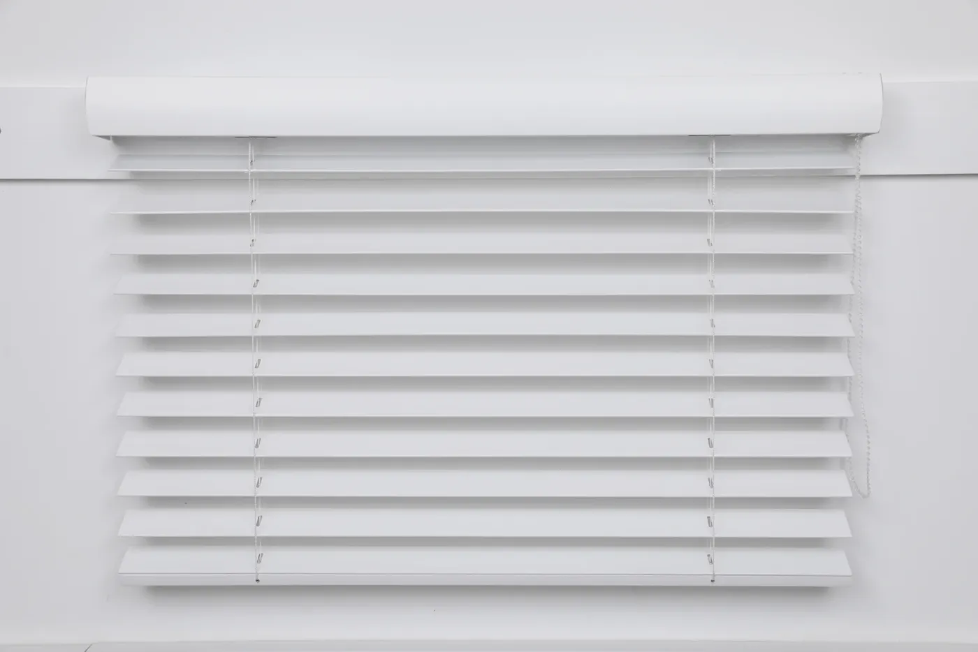 White wooden venetian blind with slats tilted open
